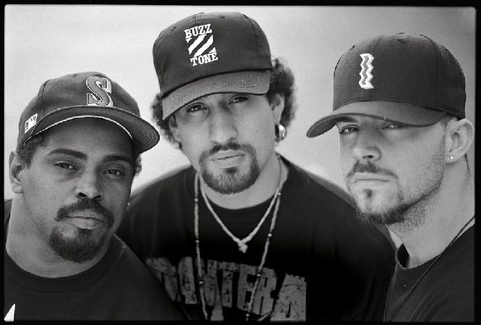 A black and white picture of DJ Muggs, B-Real, and Sen Dog